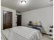 Comfortable bedroom featuring a bed, desk, and neutral decor for a versatile space at 893 Whitfield Oak Rd, Auburn, GA 30011