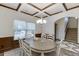 Elegant dining room with coffered ceilings, wainscoting, and a chandelier creating an inviting atmosphere at 893 Whitfield Oak Rd, Auburn, GA 30011