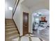 Bright foyer featuring an open staircase and views of the living room with a fireplace at 893 Whitfield Oak Rd, Auburn, GA 30011