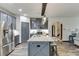 Spacious kitchen with an island featuring granite countertops, ample cabinet space, and stainless steel appliances at 893 Whitfield Oak Rd, Auburn, GA 30011