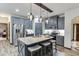 Well-equipped kitchen with granite island featuring bar seating, stainless steel appliances and pendant lighting at 893 Whitfield Oak Rd, Auburn, GA 30011