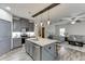 Stylish kitchen with a center island, stainless steel appliances, and gray cabinetry at 893 Whitfield Oak Rd, Auburn, GA 30011