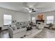 Bright and open living room featuring a cozy fireplace and neutral-toned furniture at 893 Whitfield Oak Rd, Auburn, GA 30011