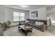 Bright living room featuring a sectional sofa and neutral decor at 893 Whitfield Oak Rd, Auburn, GA 30011