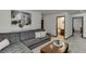 Cozy living room with a large sectional sofa and zebra art at 893 Whitfield Oak Rd, Auburn, GA 30011