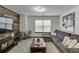 Comfortable living room with a large sectional sofa and decorative accents at 893 Whitfield Oak Rd, Auburn, GA 30011