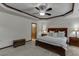 Spacious primary bedroom with a tray ceiling, comfortable seating, and a large bed at 893 Whitfield Oak Rd, Auburn, GA 30011