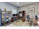 Spacious office with a brick accent wall and modern desk with shelving at 893 Whitfield Oak Rd, Auburn, GA 30011