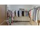 Walk-in closet featuring rods and shelves for clothing and shoes at 893 Whitfield Oak Rd, Auburn, GA 30011