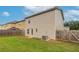 Backyard includes green grass, a wood fence, and the exterior of the two-story home at 12039 Quail Dr, Hampton, GA 30228