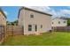 View of backyard featuring green grass, wood fence, and the exterior of the two-story home at 12039 Quail Dr, Hampton, GA 30228