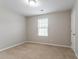 Clean bedroom with neutral carpet, natural light, and a minimalist design at 12039 Quail Dr, Hampton, GA 30228