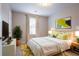 Bright bedroom featuring a plush bed, neutral walls, and decorative accents at 12039 Quail Dr, Hampton, GA 30228