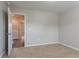 Neutral bedroom with plush carpet and an open door, providing a blank canvas at 12039 Quail Dr, Hampton, GA 30228