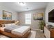 Cozy bedroom with natural light, a comfortable bed, and a mounted TV for relaxation at 12039 Quail Dr, Hampton, GA 30228