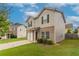 Two-story home with stone accents, an attached garage, manicured landscaping, and a concrete driveway at 12039 Quail Dr, Hampton, GA 30228