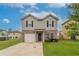 Charming two-story home featuring a brick facade, attached garage, and well-maintained lawn at 12039 Quail Dr, Hampton, GA 30228