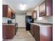 Kitchen with wood cabinets, black appliances, neutral walls, and light wood-look floors at 12039 Quail Dr, Hampton, GA 30228