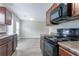 Kitchen with stainless steel appliances, wood cabinets, luxury vinyl flooring, and neutral paint at 12039 Quail Dr, Hampton, GA 30228
