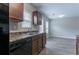 Kitchen with stainless steel appliances, a dual basin sink, wood cabinets, and luxury vinyl flooring at 12039 Quail Dr, Hampton, GA 30228