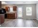 Eat-in kitchen features wood floors, stainless appliances, and a door to the exterior of the home at 12039 Quail Dr, Hampton, GA 30228