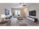 Bright living room featuring luxury vinyl floors, natural light, white furniture and modern décor at 12039 Quail Dr, Hampton, GA 30228