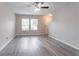 Spacious living room featuring luxury vinyl floors, neutral walls, and a stairway to the second floor at 12039 Quail Dr, Hampton, GA 30228