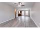 Open-concept living room with modern gray vinyl flooring, ceiling fan, and lots of natural light at 12039 Quail Dr, Hampton, GA 30228