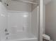 Shower and tub in this bathroom features a built-in soap holder, shower head, and shower rod at 12039 Quail Dr, Hampton, GA 30228