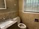 Bathroom with tiled walls, granite-top vanity, and window with blinds at 2436 Glenrock Dr, Decatur, GA 30032