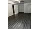 Spacious bedroom featuring wood floors, a ceiling fan, and ample closet space at 2436 Glenrock Dr, Decatur, GA 30032