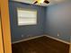 This bedroom features lovely blue walls, hardwood floors, and a ceiling fan at 2436 Glenrock Dr, Decatur, GA 30032