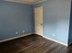 Inviting bedroom with wood-look floors, natural light, and a door for easy access at 2436 Glenrock Dr, Decatur, GA 30032