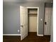 Bedroom with hardwood floors, grey walls, closet, and white trim at 2436 Glenrock Dr, Decatur, GA 30032