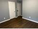 Bedroom with hardwood floors, grey walls, closet, and white trim at 2436 Glenrock Dr, Decatur, GA 30032