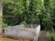 Outdoor wooden deck surrounded by dense trees at 2436 Glenrock Dr, Decatur, GA 30032