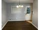 Dining area featuring hardwood floors, modern light fixture and an exterior entrance door at 2436 Glenrock Dr, Decatur, GA 30032