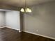 Dining room featuring hardwood floors, overhead chandelier and modern gray painted walls at 2436 Glenrock Dr, Decatur, GA 30032