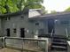 Rear view of the home with dual entrances, painted brick and a raised porch area at 2436 Glenrock Dr, Decatur, GA 30032