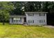 Charming home featuring a well-manicured lawn, gray brick facade and neatly trimmed shrubbery at 2436 Glenrock Dr, Decatur, GA 30032