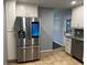 Kitchen with stainless steel smart refrigerator, white cabinets, tile floor, and stainless steel appliances at 2436 Glenrock Dr, Decatur, GA 30032