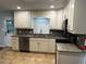 Bright kitchen features white cabinets, granite countertops, stainless steel appliances and stylish backsplash at 2436 Glenrock Dr, Decatur, GA 30032