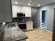 Updated kitchen with stainless steel appliances and granite countertops, and open access to stairs at 2436 Glenrock Dr, Decatur, GA 30032