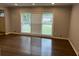 Living room with large window, blinds and hardwood floors with modern gray paint at 2436 Glenrock Dr, Decatur, GA 30032