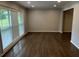 Living room with large window, blinds and hardwood floors with modern gray paint at 2436 Glenrock Dr, Decatur, GA 30032