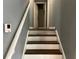 Elegant staircase showcasing a painted handrail, neutral walls, and wood treads at 2436 Glenrock Dr, Decatur, GA 30032