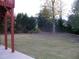 Serene backyard features lush greenery, privacy hedges, and a well-kept lawn at 4576 Creek Forestt Trl, Lilburn, GA 30047