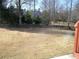 Spacious backyard offering mature evergreens in a well-maintained and level landscape at 4576 Creek Forestt Trl, Lilburn, GA 30047