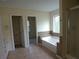 Bright bathroom featuring a tub, a vanity, and tile flooring at 4576 Creek Forestt Trl, Lilburn, GA 30047