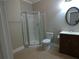 Bathroom features a walk-in shower, toilet, and vanity with a mirror at 4576 Creek Forestt Trl, Lilburn, GA 30047